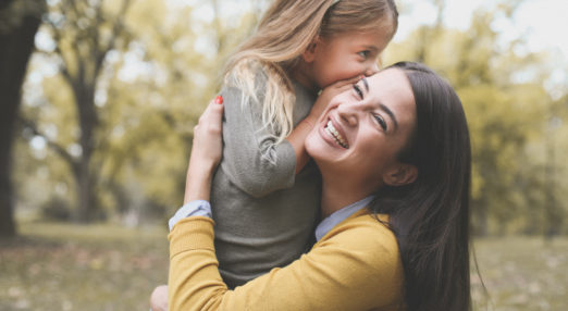 Image of a mother and child smiling in a park