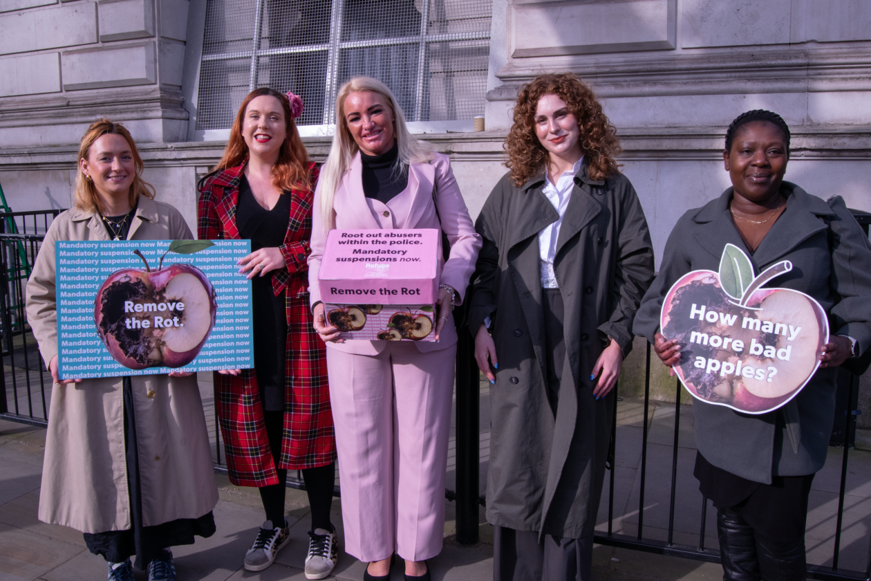 A group of 5 women holding placards and a box containing a petition to government